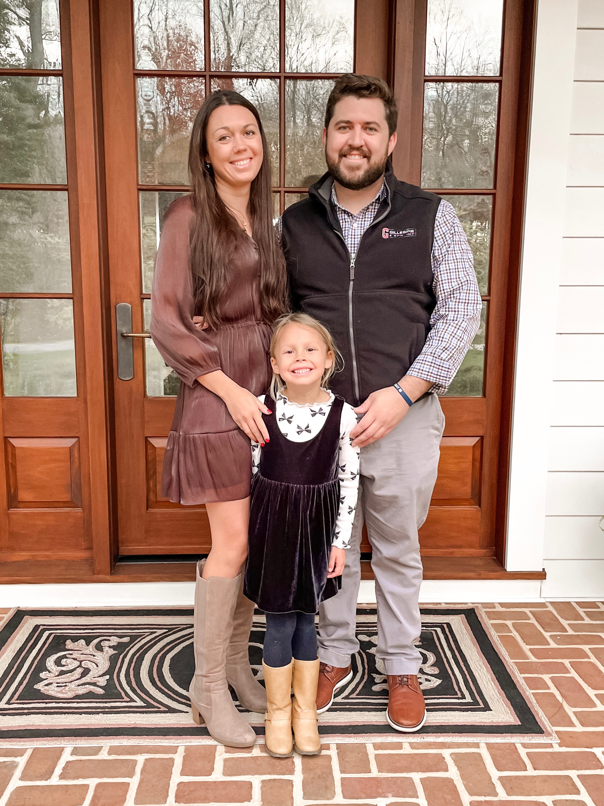 Conner with his wife Taylor and their daughter on their front porch
